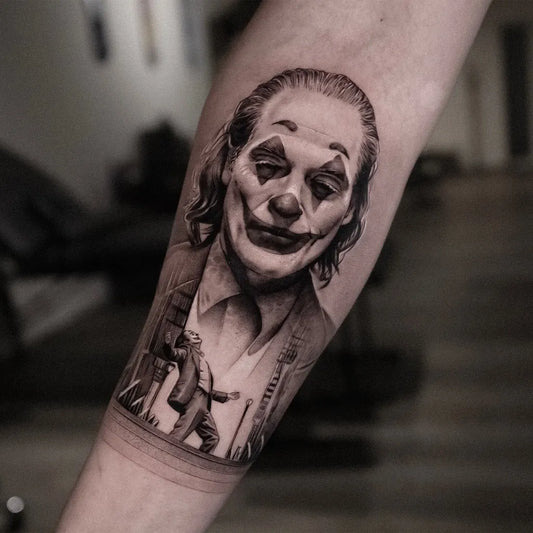 Medium Black and Grey Joker Portrait with Cityscape on Men Arm Tattoo by @inalbersekov