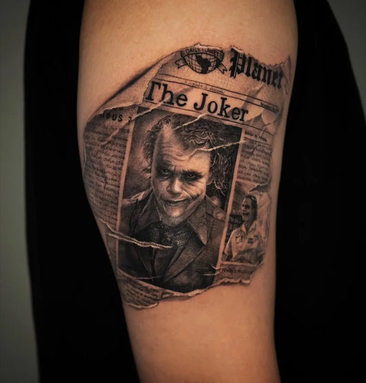 Medium Black and Grey Joker newspaper on Men Arm Tattoo by @mstattooer