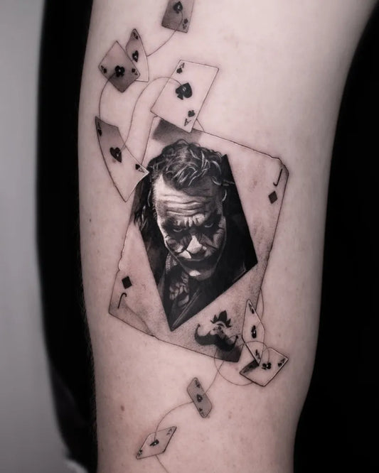 Medium Black and Grey Joker with Aces on Men Arm Tattoo by @notorious_ink.ulm