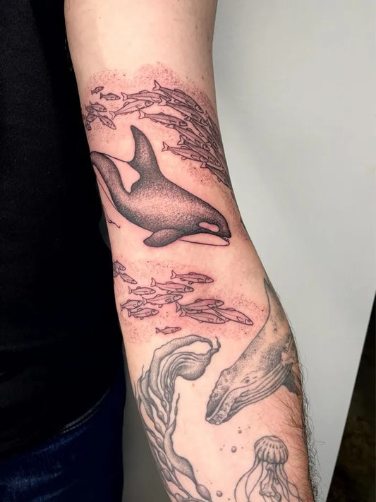 Medium Black and Grey Killer Whale and Fish Tattoo on Men Arm by @overzealous.ink