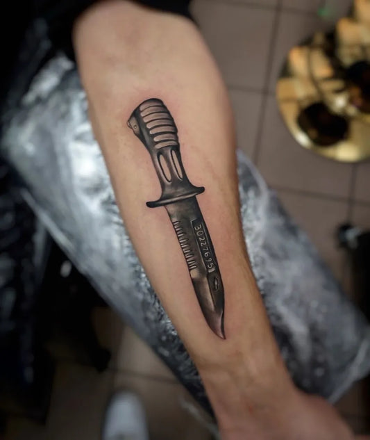 Medium Black and Grey Knife Military Tattoo on Men Arm by @santamariatattoo.uk