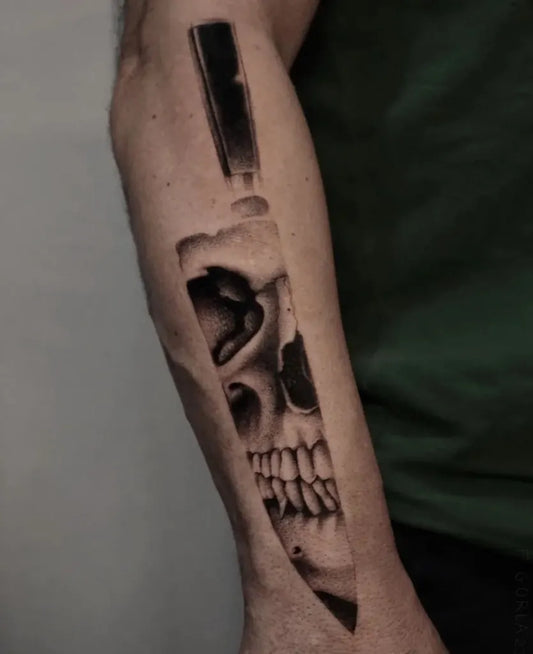 Medium Black and Grey Knife Skull Tattoo on Men Arm by @sailorstattoomilanoduomo