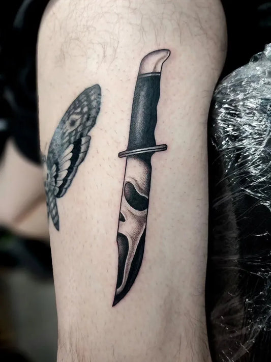 Medium Black and Grey Knife and Moth Tattoo on Men Arm by @tawwdd