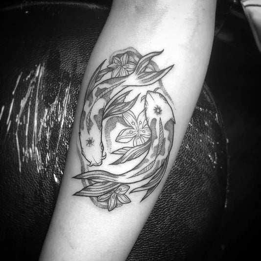 Medium Black and Grey Koi Fish and Lotus Tattoo on Women Arm by @mialocatattoo