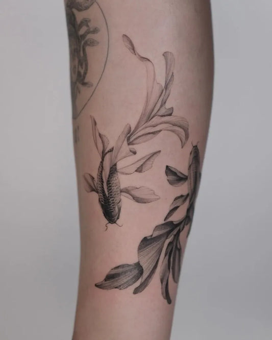 Medium Black and Grey Koi Fish and Lotus Tattoo on Women Arm by @sosnovska.tattoo
