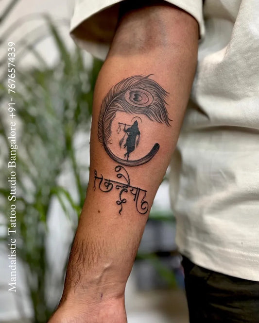 Medium Black and Grey Krishna Feather Tattoo on Men Arm by @mandalistictattoostudio
