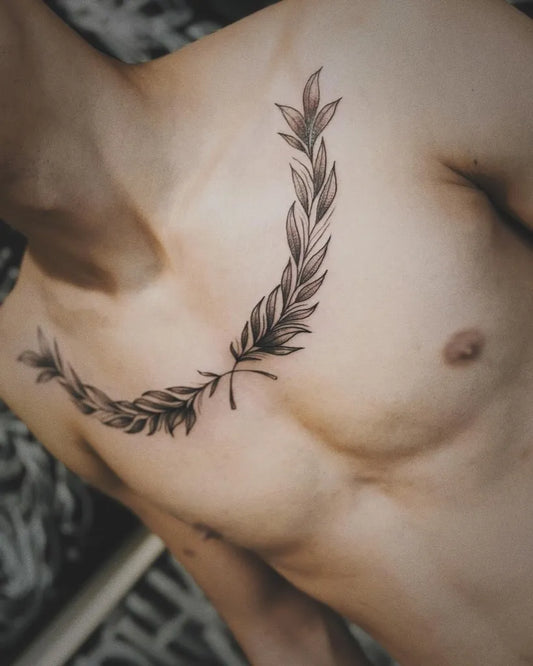 Medium Black and Grey Laurel Wreath Tattoo on Men Chest by @ssprada.tattoo