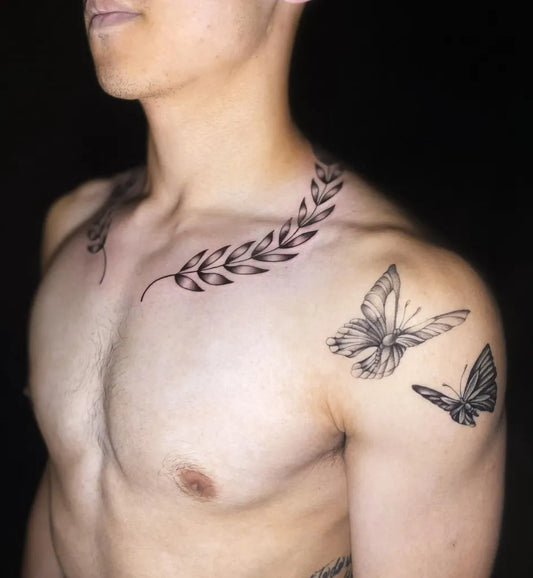 Medium Black and Grey Laurel Wreath and Butterflies Tattoo on Men Shoulder by @kaki_claratattoos