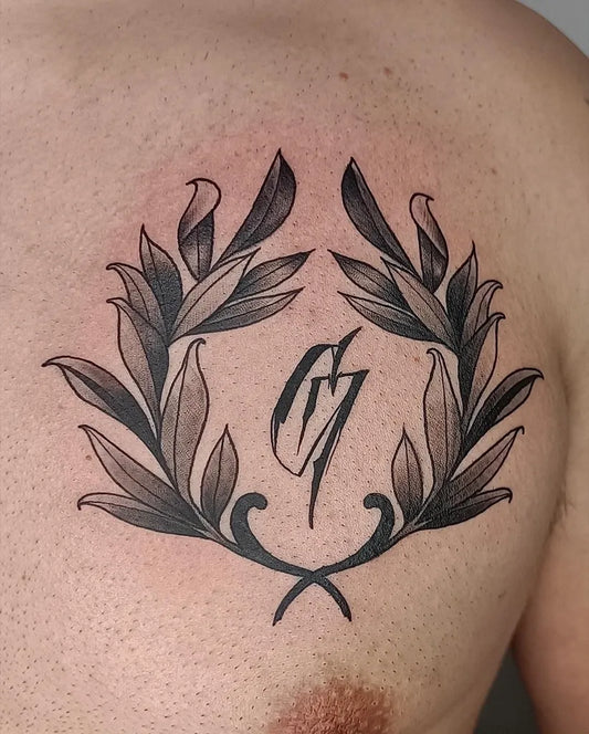 Medium Black and Grey Laurel Wreath with Letters Tattoo on Men Chest by @jay__tattooer