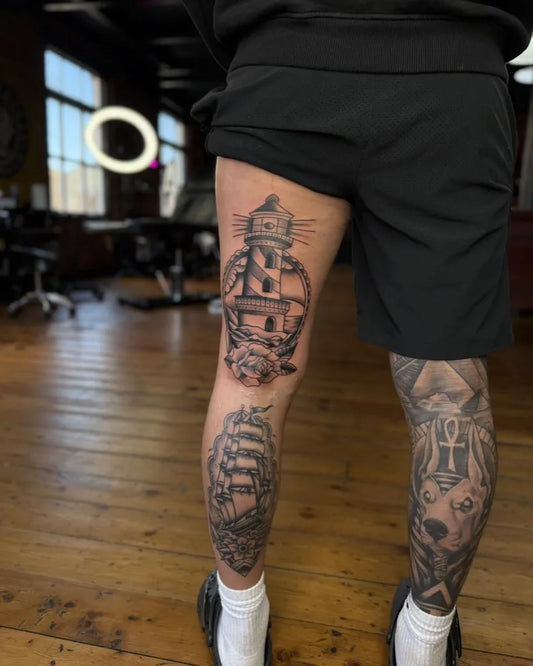 Medium Black and Grey Lighthouse Ship Tattoo on Men Thigh by @oliveandweston