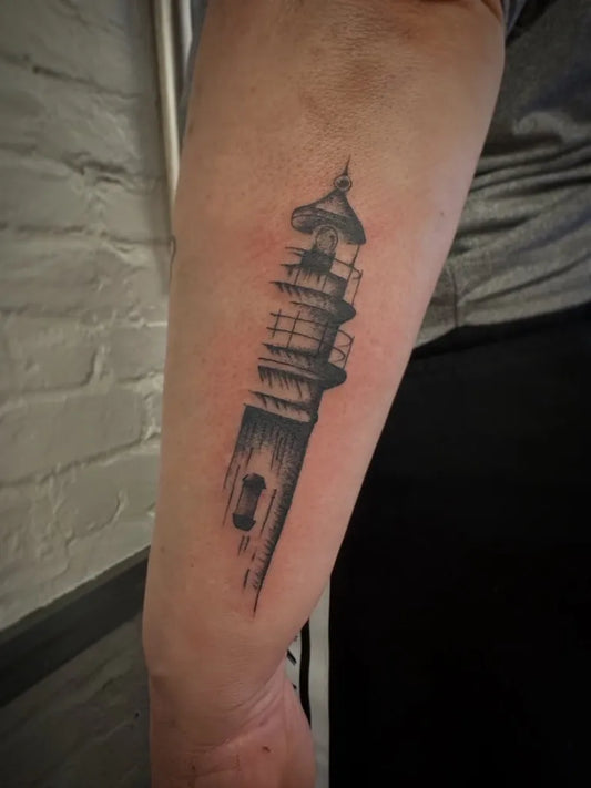 Medium Black and Grey Lighthouse Tattoo on Men Arm by @libertycentertattooshop