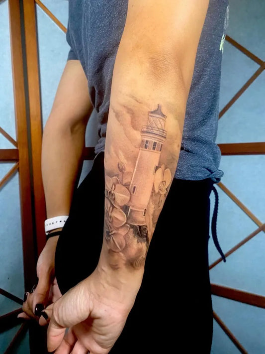 Medium Black and Grey Lighthouse with Clouds and Waves Tattoo on Men Arm by @melo_gia_tattoo