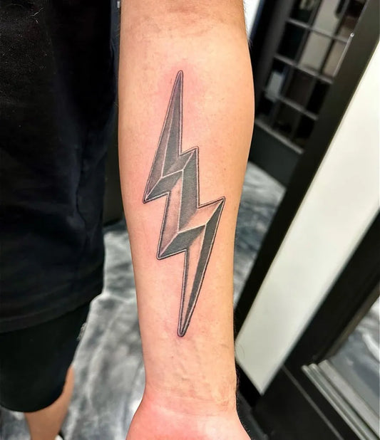 Medium Black and Grey Lightning Bolt Tattoo on Men Arm by @studio_seven_tattoos
