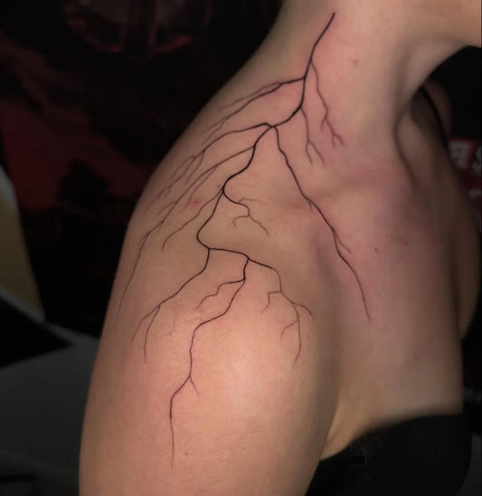 Medium Black and Grey Lightning Bolts Tattoo on Women Shoulder by @fine.mente