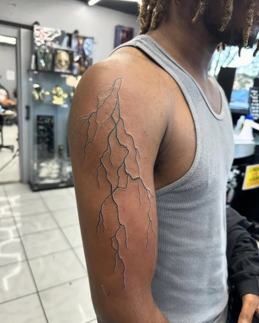 Medium Black and Grey Lightning Tattoo on Men Shoulder by @tattoo_kings20