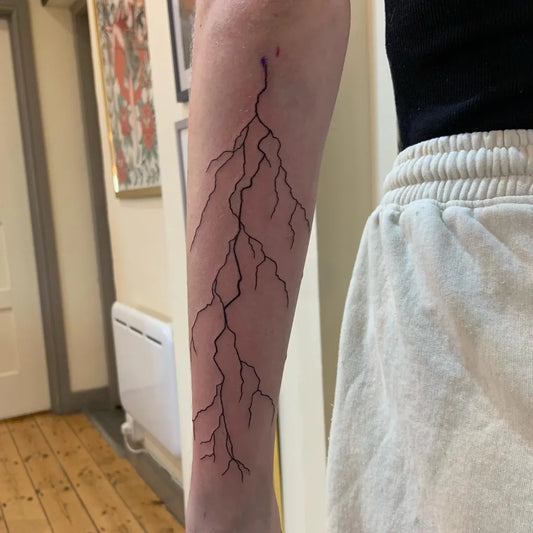 Medium Black and Grey Lightning Tattoo on Women Arm by @lucyannetattoo