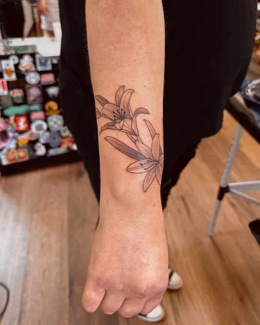 Medium Black and Grey Lily Flower Spiritual Tattoo on Women Forearm by @sarahpeteh
