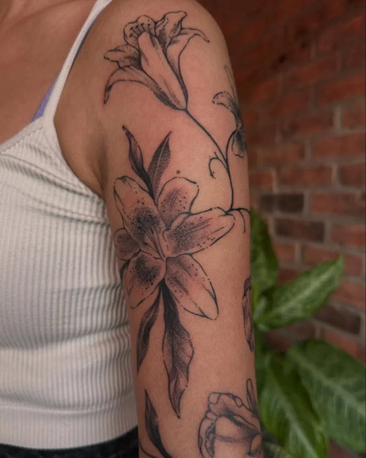 Medium Black and Grey Lily Flowers Tattoo on Women Arm by @fishcake.tats