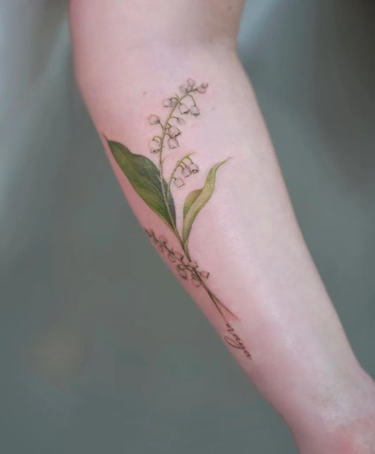 Medium Black and Grey Lily of the Valley Flowers and Leaves on Women Arm Tattoo by @tattooartbyhailey