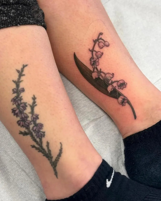 Medium Black and Grey Lily of the Valley and Heather on Women Legs Tattoo by @daughterofmars.tattoos