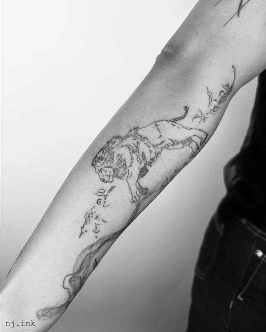 Medium Black and Grey Lion with Flowers on Women Arm Tattoo by @nj.ink
