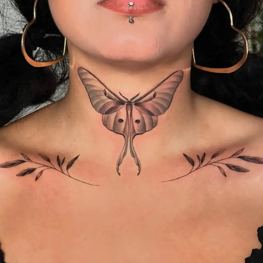 Medium Black and Grey Luna Moth and Leaves Tattoo on Women Collarbone by @belovedtattoos