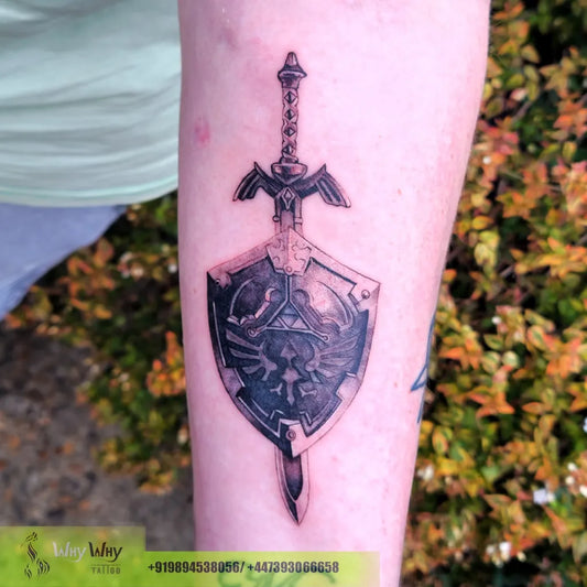 Medium Black and Grey Master Sword and Hylian Shield on Men Arm Tattoo by @whywhy_tattoo