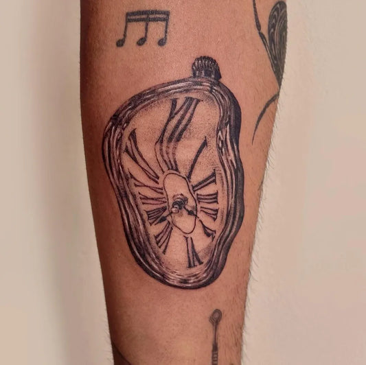 Medium Black and Grey Melting Clock Tattoo on Men Arm by @suim.ink
