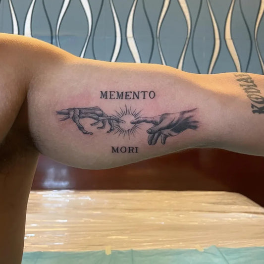 Medium Black and Grey Memento Mori Hands with Sun on Men Upper Arm Tattoo by @dmrsnts