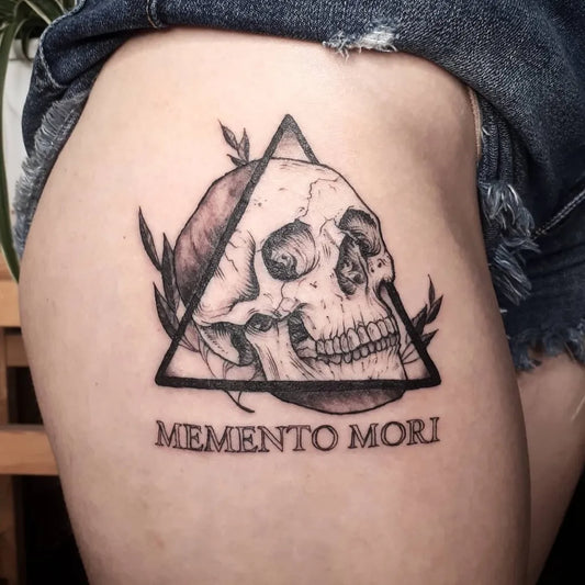 Medium Black and Grey Memento Mori Skull with Laurel on Women Thigh Tattoo by @dallasconte