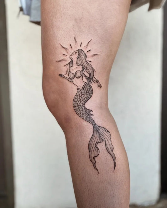 Medium Black and Grey Mermaid with Sun Tattoo on Women Thigh by @annah.tattoo