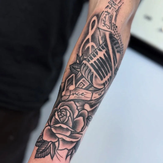 Medium Black and Grey Microphone Rose Music Tattoo on Men Arm by @aaronbruce