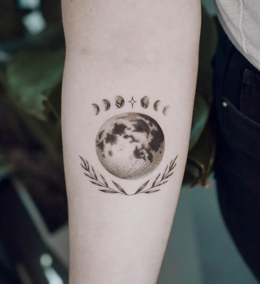 Medium Black and Grey Moon Phases Laurel Moon Tattoo on Women Arm by @frankly.sasha.tattoo