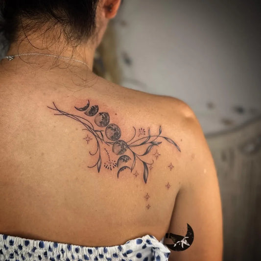 Medium Black and Grey Moon Phases and Floral Branches Tattoo on Women Shoulder by @tinta_bruja