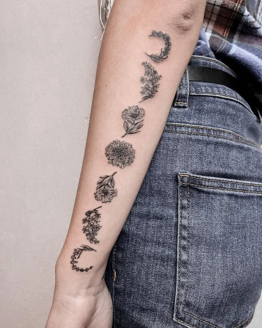 Medium Black and Grey Moon Phases and Flowers Tattoo on Women Arm by @olha.steblii