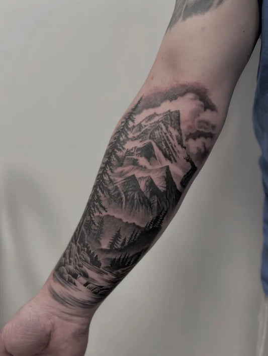 Medium Black and Grey Mountain Forest Tattoo on Men Arm by @otautahitattooqueenstown