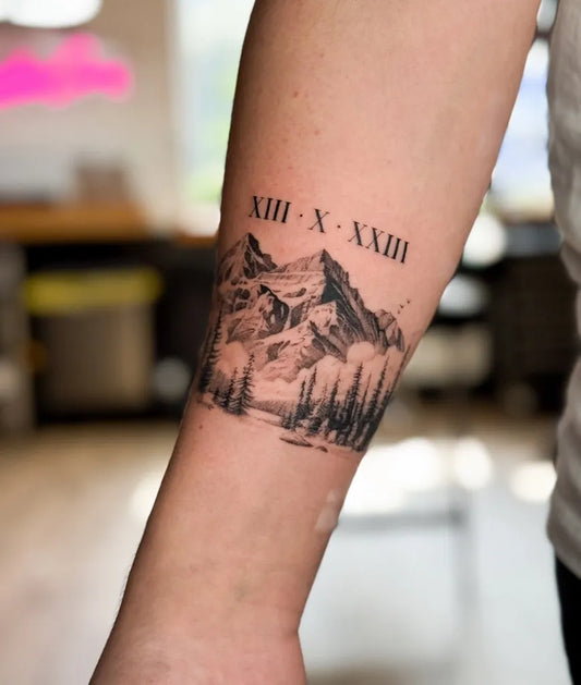Medium Black and Grey Mountain and Roman Numerals Tattoo on Men Arm by @jayke_cox