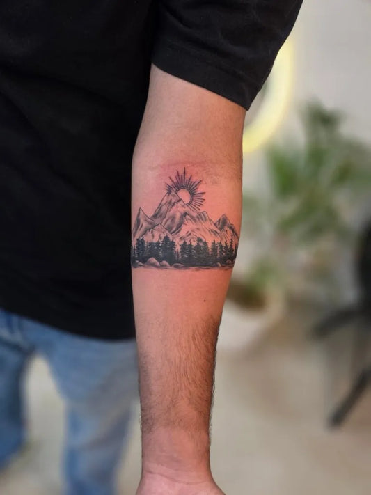 Medium Black and Grey Mountain and Sun Tattoo on Men Arm by @vimoksha_tattoos