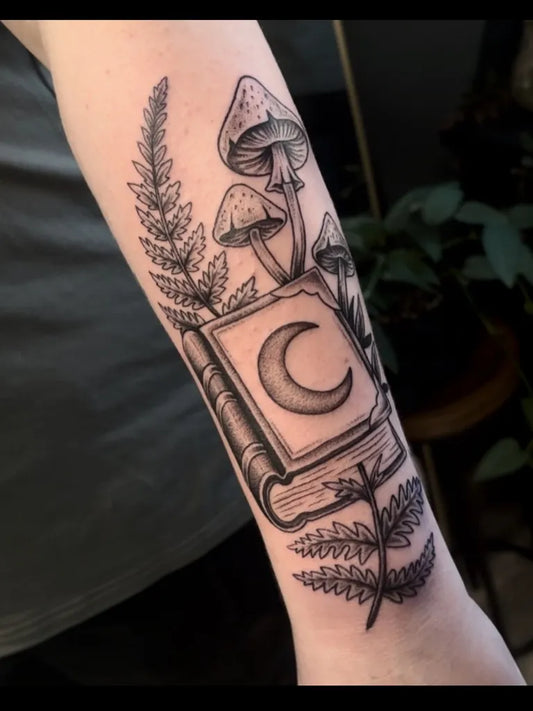 Medium Black and Grey Mushroom Book and Fern on Women Arm Tattoo by @fabledhand.tattoo