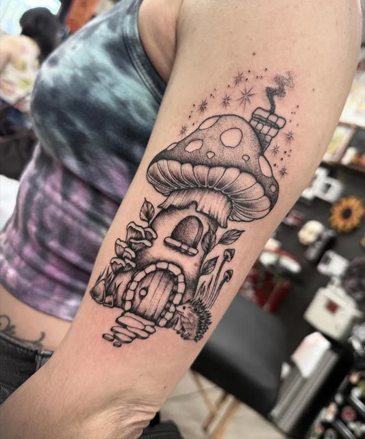 Medium Black and Grey Mushroom House with Hedgehog on Women Arm Tattoo by @emilycolgantattoos