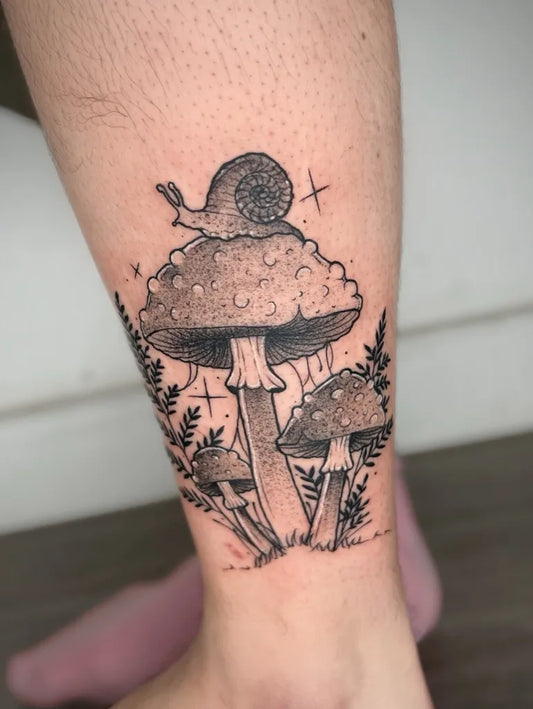 Medium Black and Grey Mushroom and Snail on Women Leg Tattoo by @agnan_tattoo