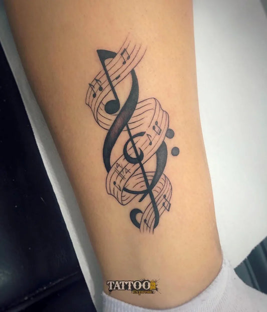 Medium Black and Grey Musical Notes Tattoo on Women Thigh by @taxi_tattoo_express