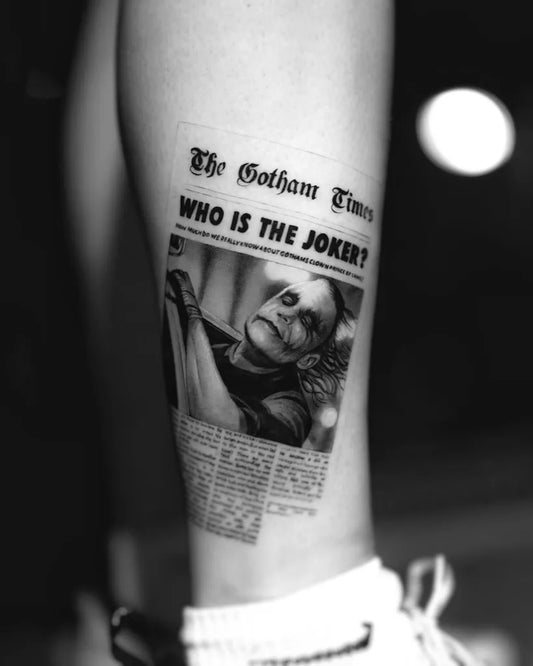 Medium Black and Grey Newspaper with Joker on Women Leg Tattoo by @ornatus.33