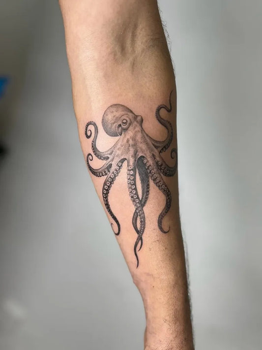 Medium Black and Grey Octopus Tattoo on Men Arm by @delamartattoo