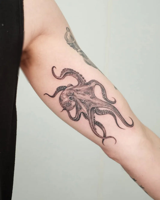 Medium Black and Grey Octopus Tattoo on Men Arm by @grayscale.tattoo