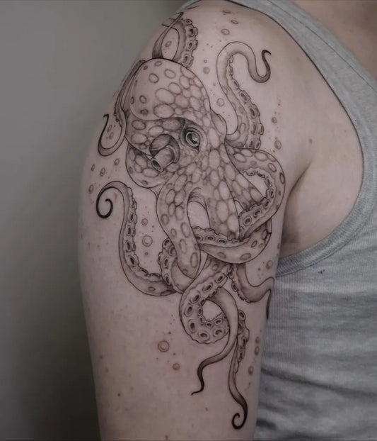 Medium Black and Grey Octopus Tattoo on Men Arm by @justine.tattoo