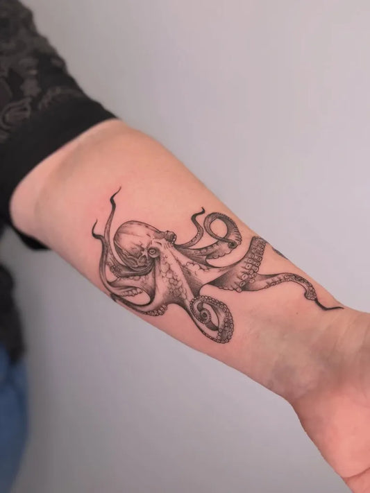 Medium Black and Grey Octopus Tattoo on Women Arm by @danieldtattooartist