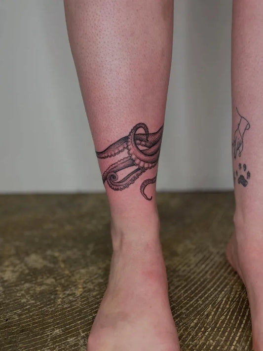 Medium Black and Grey Octopus Wrap Tattoo on Women Leg by @overzealous.ink