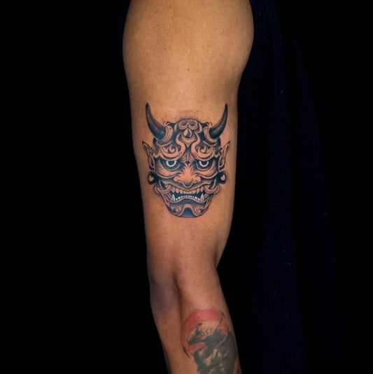 Medium Black and Grey Oni Mask on Men Arm Tattoo by @lawrence.tattoos