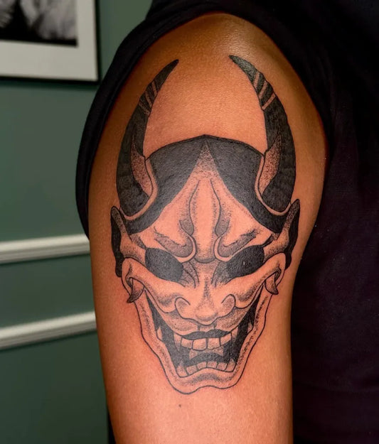 Medium Black and Grey Oni Mask on Men Arm Tattoo by @tesstic.tattoos